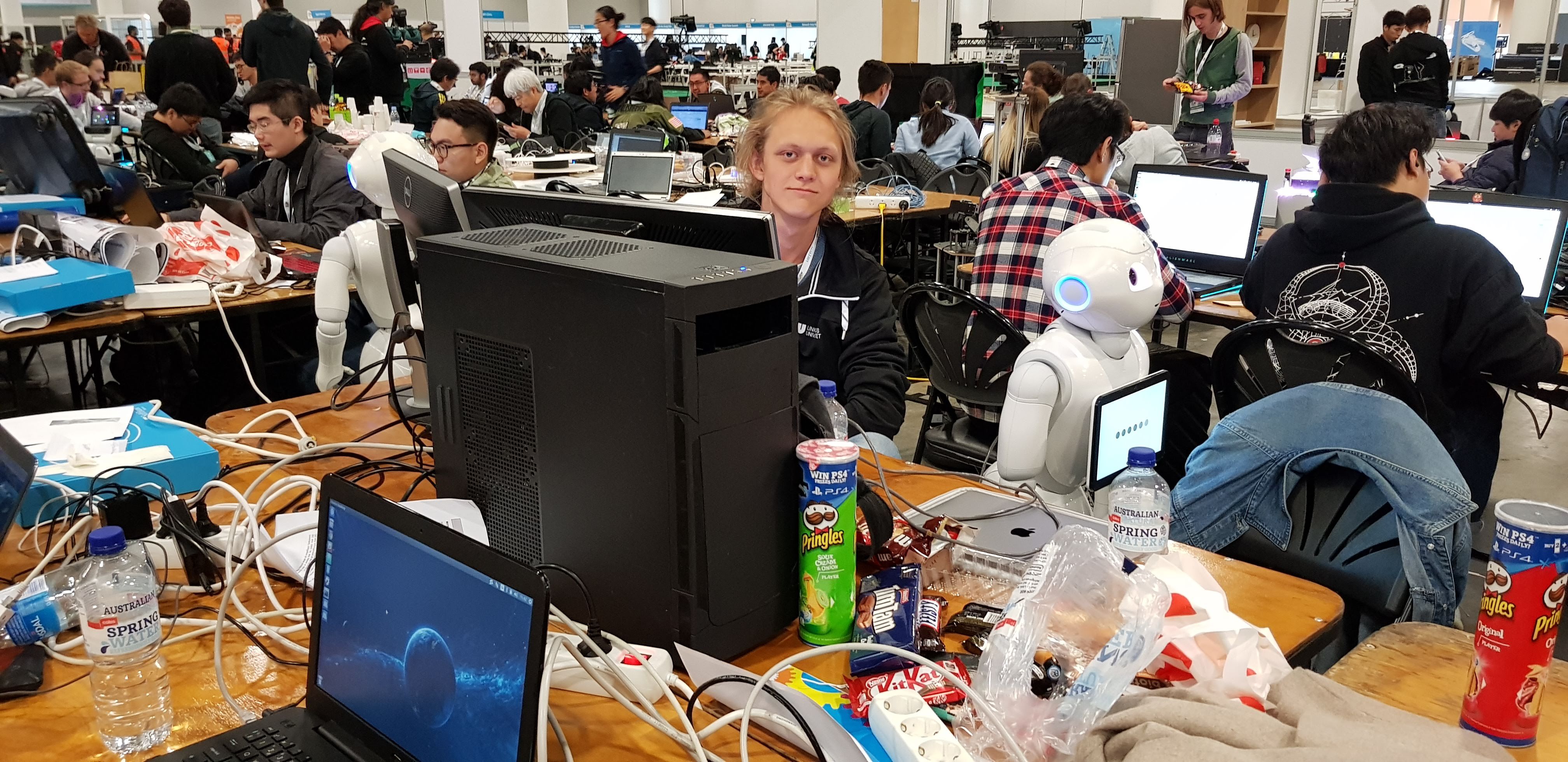 Axel Wickman programming in the middle of the RoboCup convention floor in Sydney.